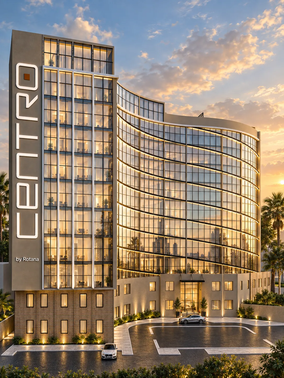 Upright view of the solid service wall with the illuminated Centro sign, the curved glazing sweeping away behind it at sunset.