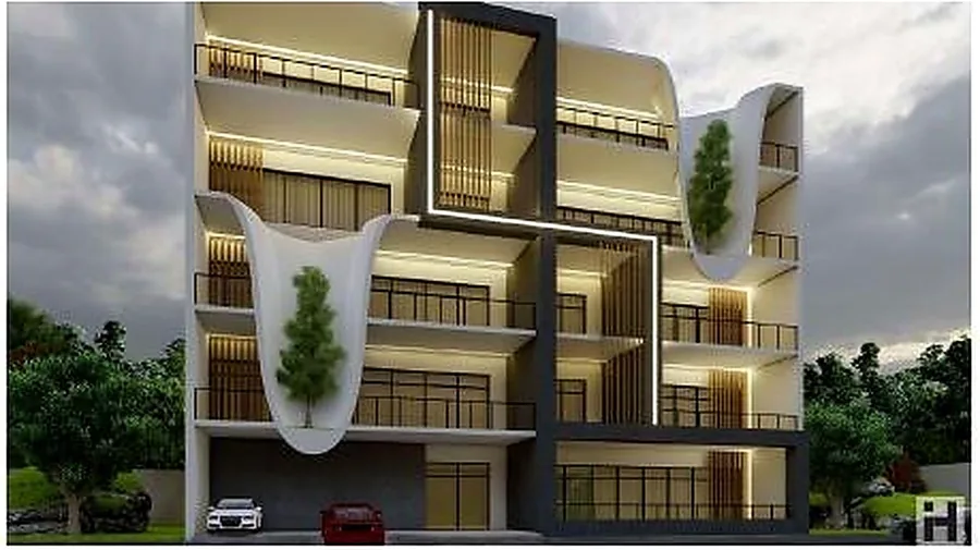 The mixed-use building from the opposite corner, curved balcony forms across the upper floors.