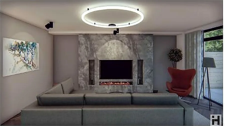 Family living room with a stone fireplace wall, soft grey seating and a red accent chair.