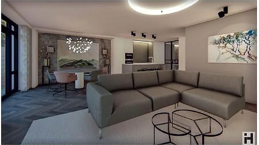 The living space opening towards the dining table and kitchen beyond.
