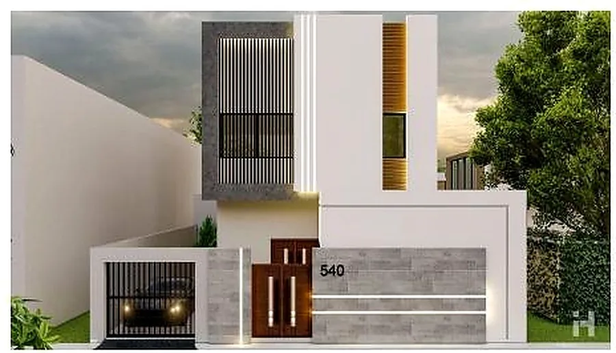 The same villa lit at night, the vertical entrance glowing between solid walls.