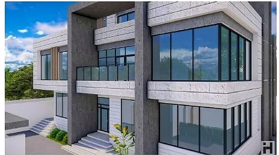 Villa with a fully glazed corner opening between solid rendered volumes.