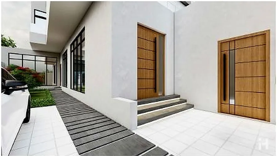 Paved approach to a villa with a tall timber door set in a white frame.